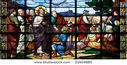 stock-photo-stained-glass-window-in-st-sulpice-church-fougeres-france-depicting-a-biblical-scene-miracle-of-21604885.jpg